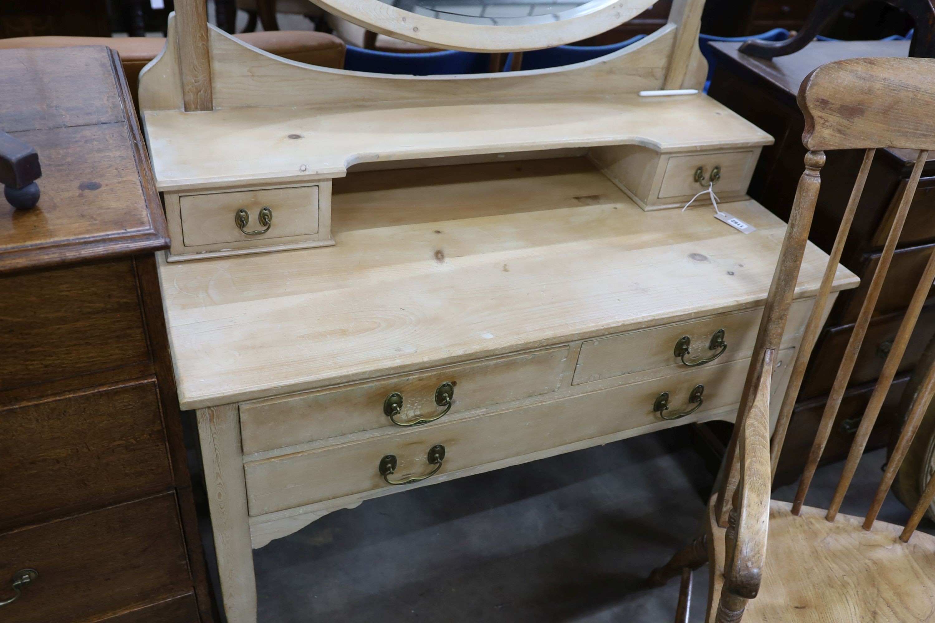 An Edwardian pine dressing table, width 106cm, depth 51cm, height 154cm together with a Victorian elm and beech Windsor armchair